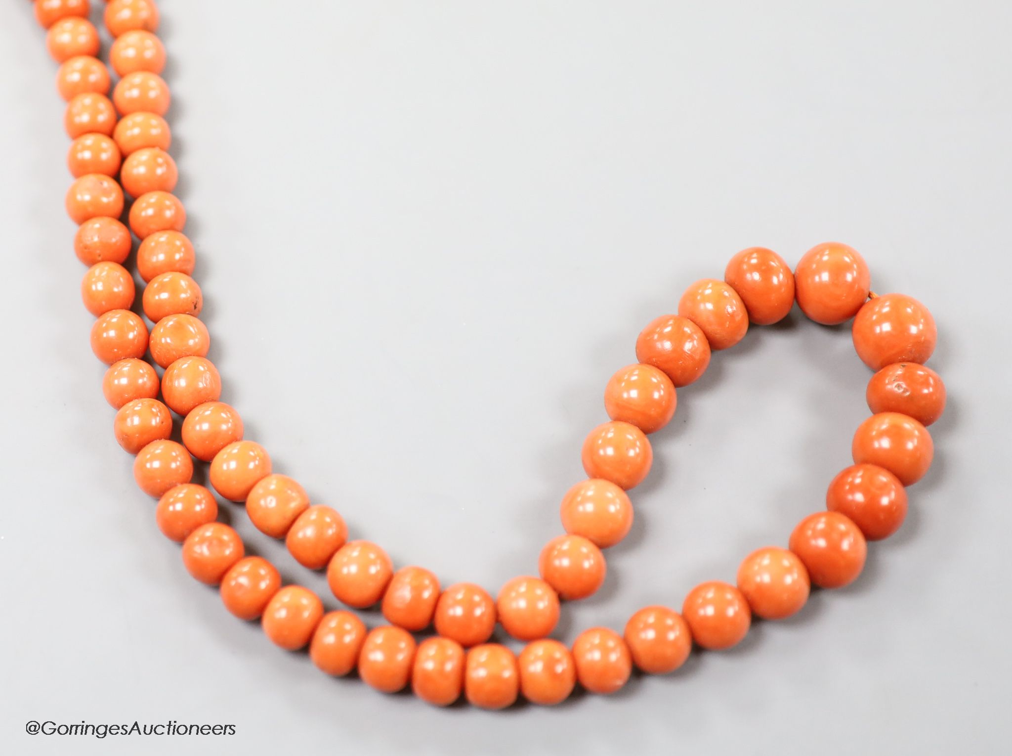 A large single strand graduated coral bead necklace, with yellow metal clasp, 80cm, gross weight 123 grams